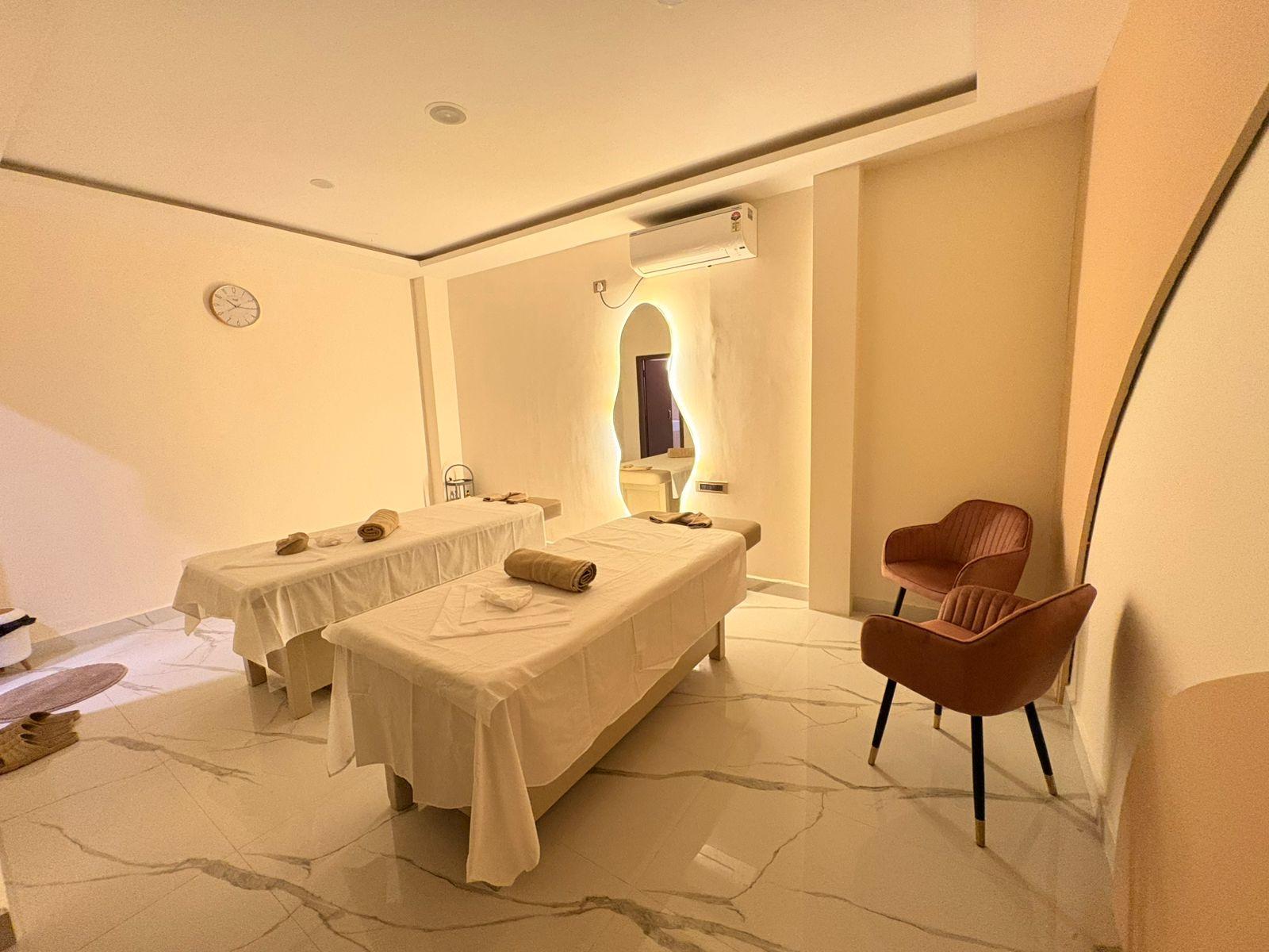 Two massage tables and a backlit mirror at Soulscape Elite