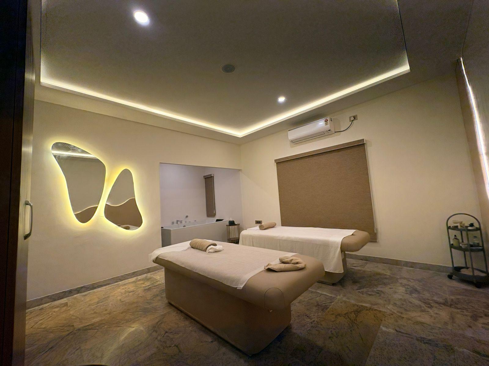 Couple room with a glowing organic mirror at Soulscape Elite