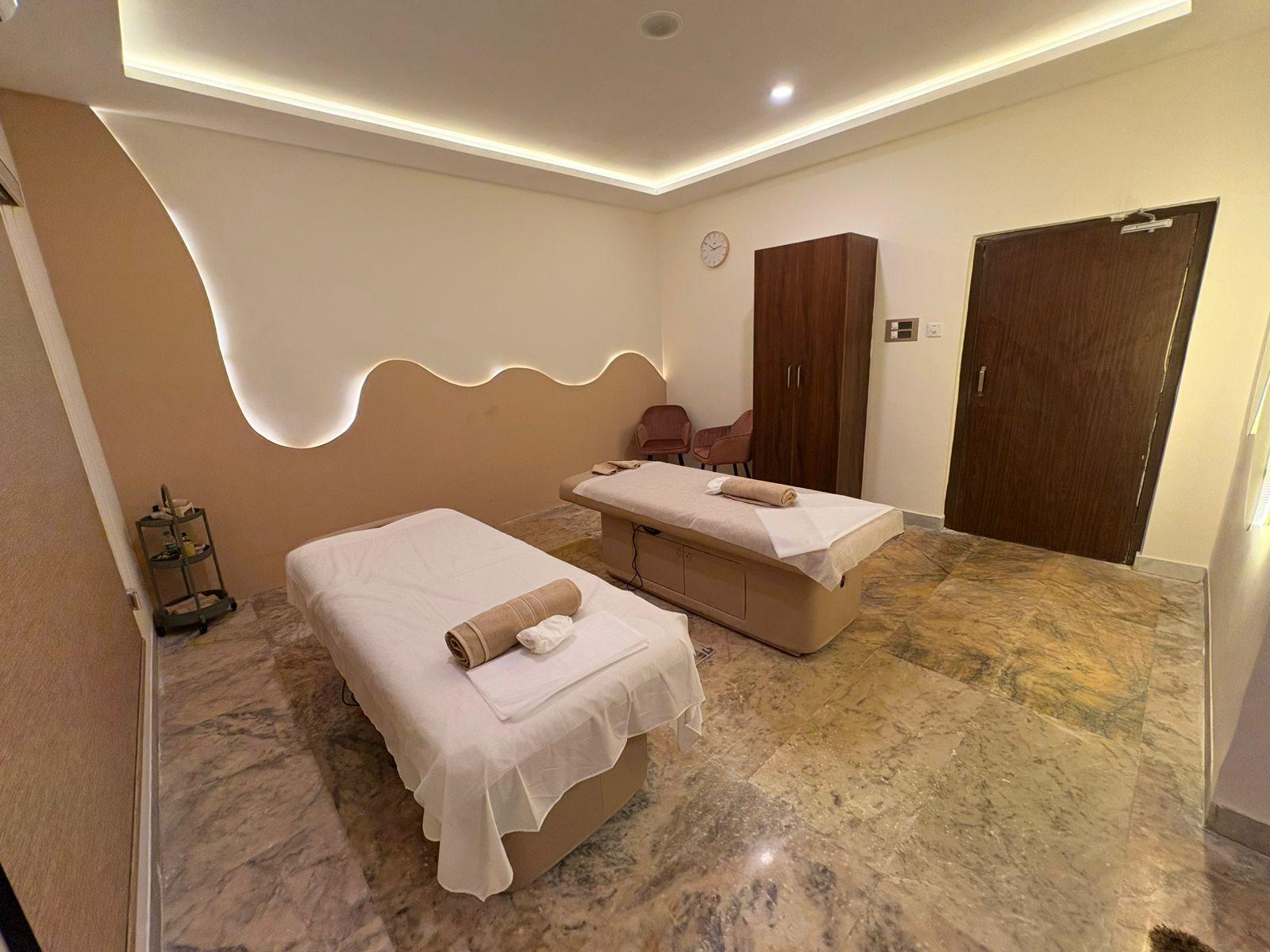 Massage room with a sculpted wave wall at Soulscape Elite
