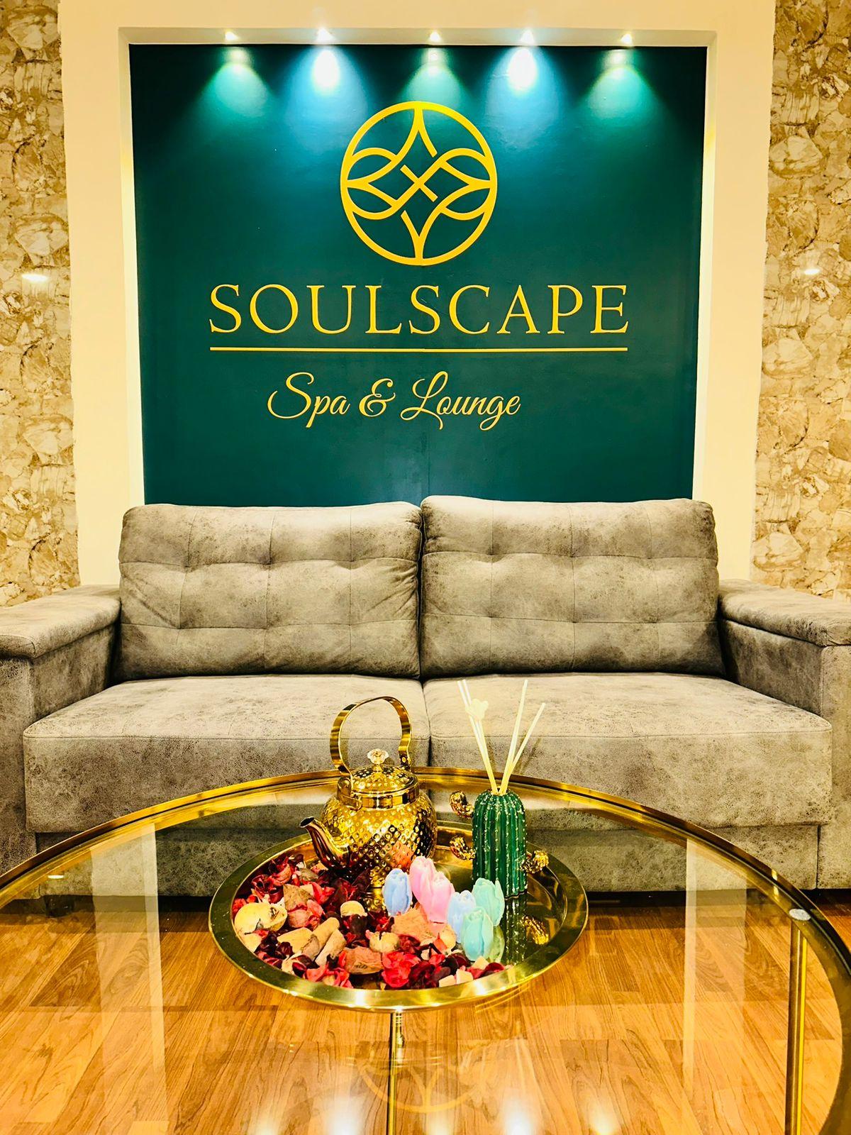 Sofa in front of the emerald Soulscape logo wall at Somajiguda