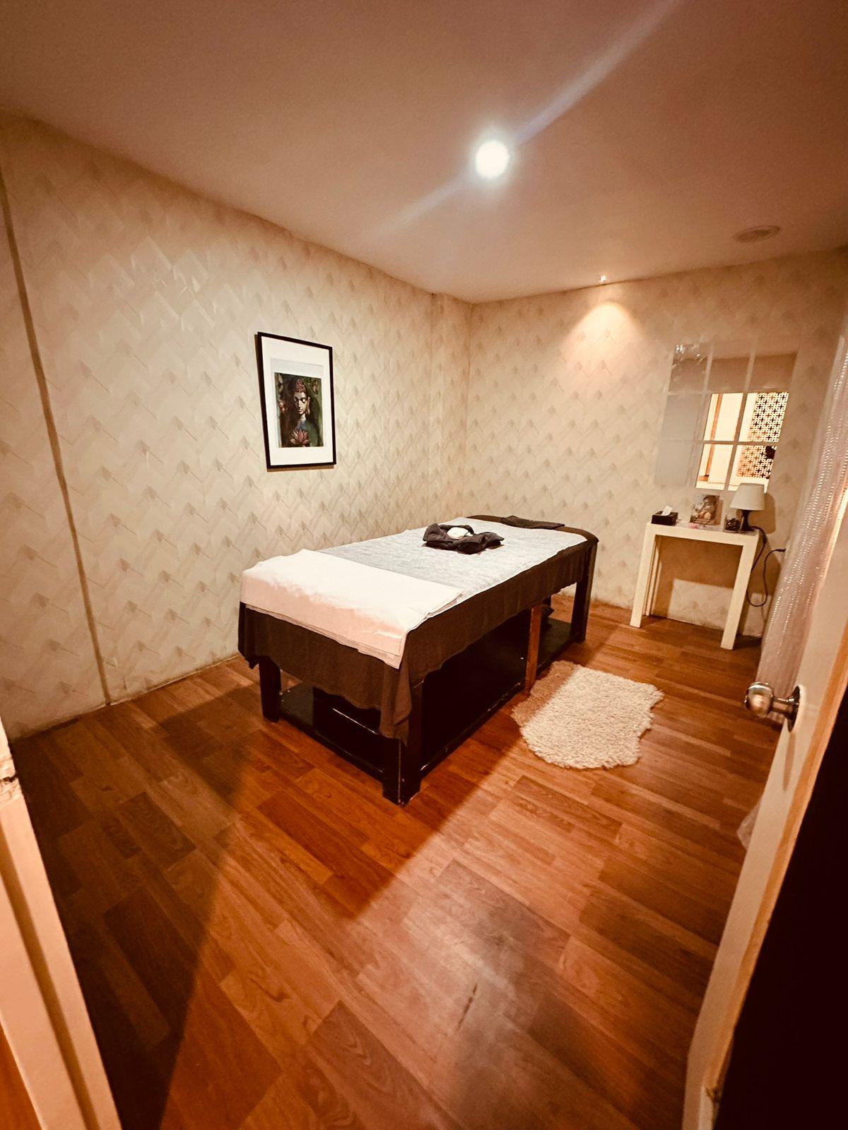 Massage room with a wooden floor at Somajiguda